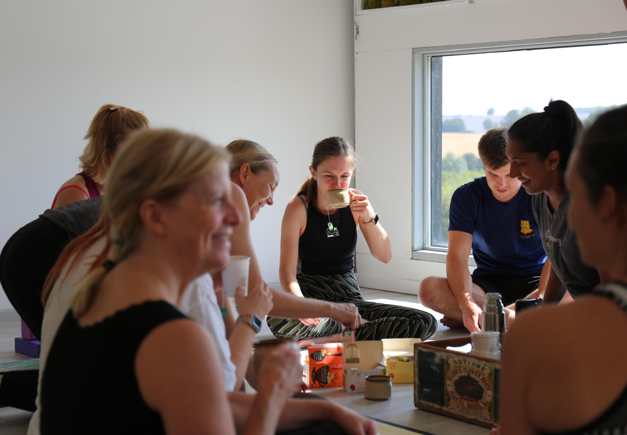 Thaxted Wellness Hub Community members sharing tea and conversation after class at Thaxted Wellness Hub, Essex